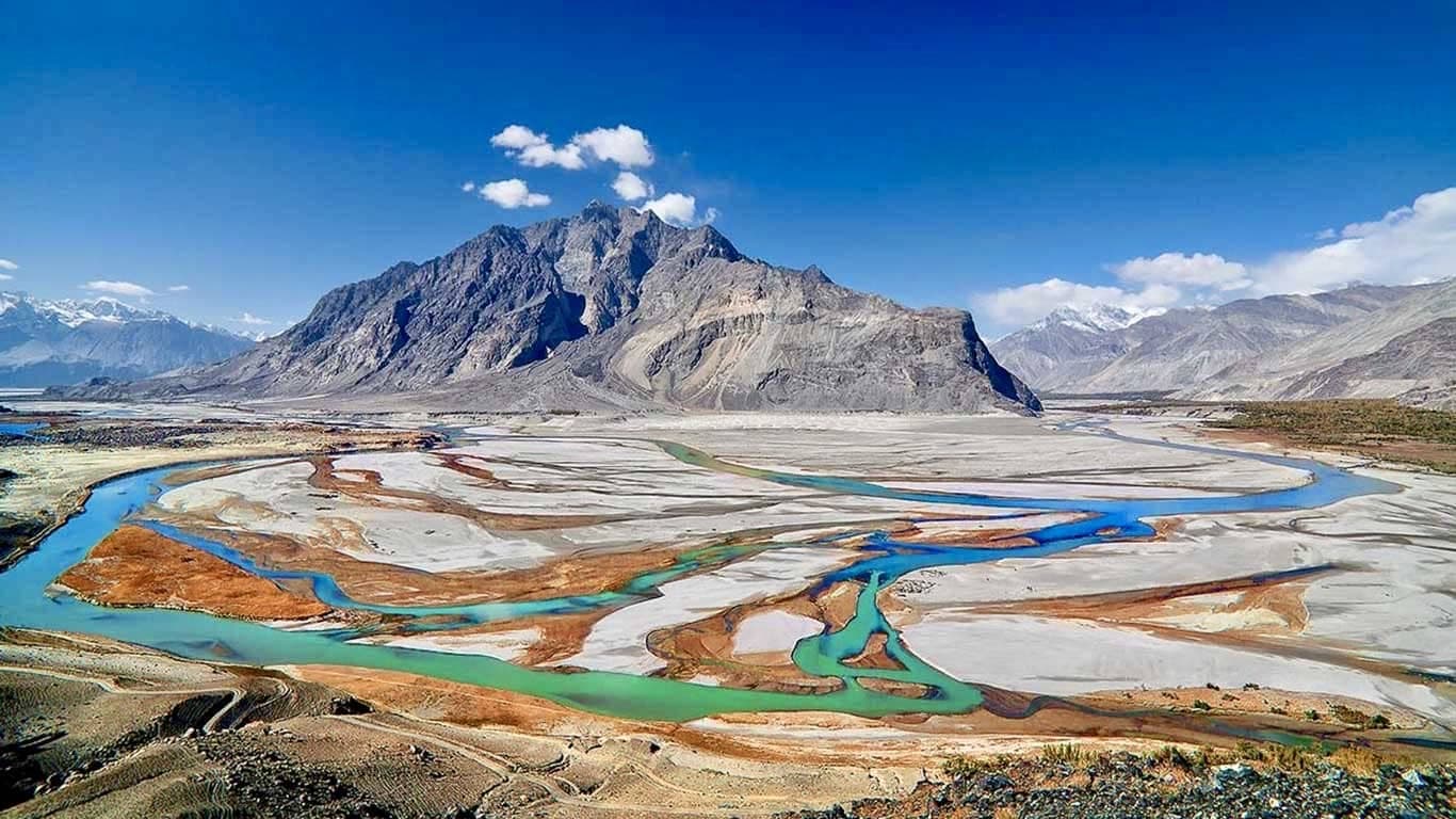 The braided Shigar river below bare peaks, the valley the Khosar Gang approach follows