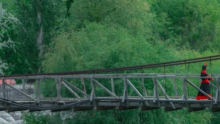 A footbridge over the river in a Kalash valley
