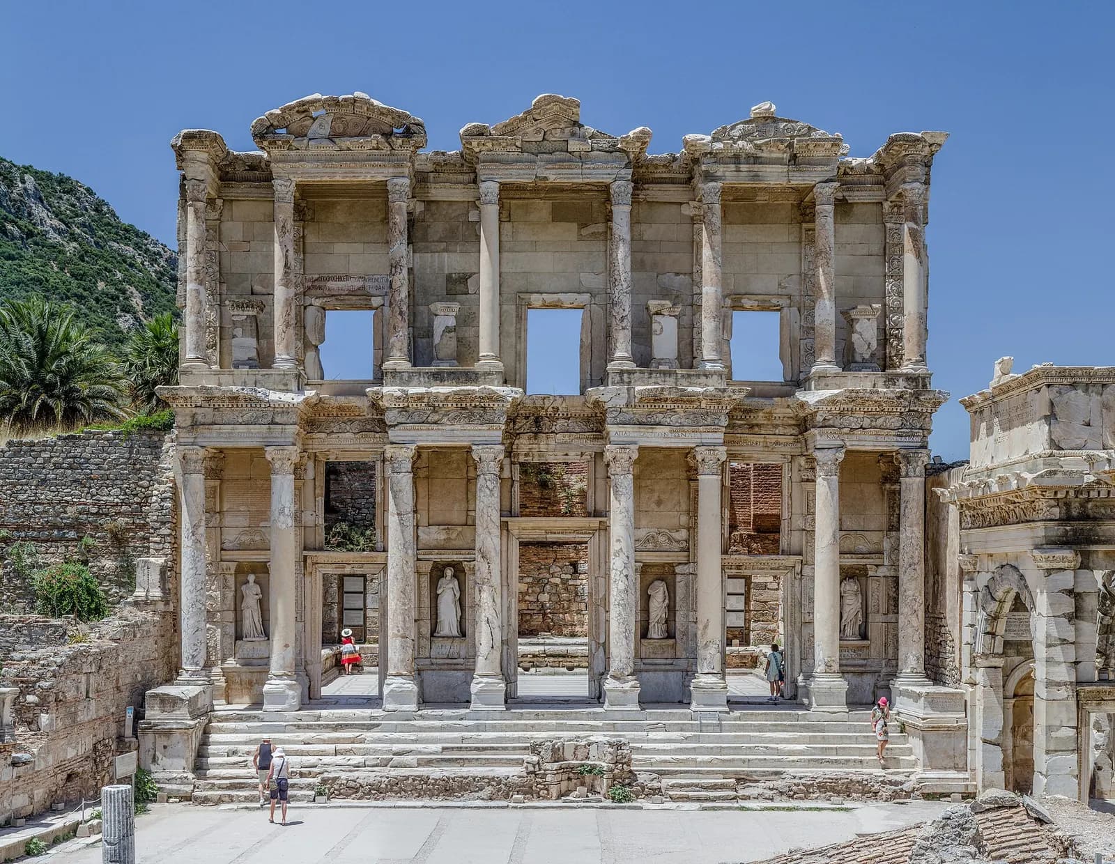 The restored two-storey marble façade of the Library of Celsus at Ephesus, with columns, statues in niches and steps in front
