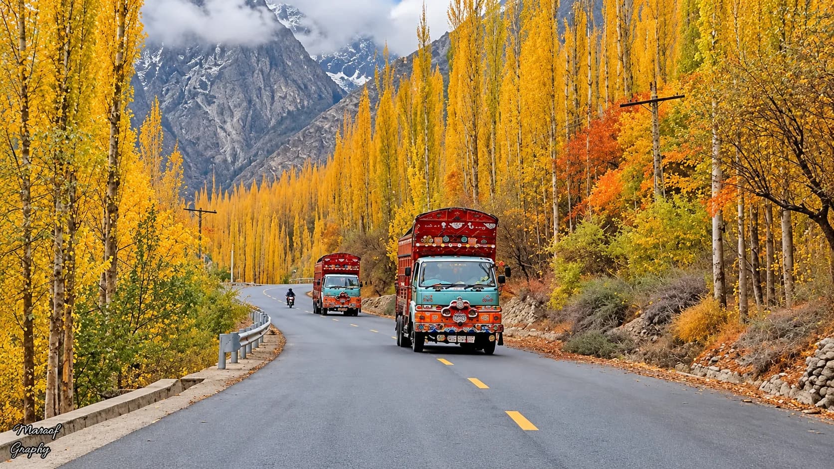 Decorated truck driving on the Karakoram Highway beneath the Passu Cones in Pakistan
