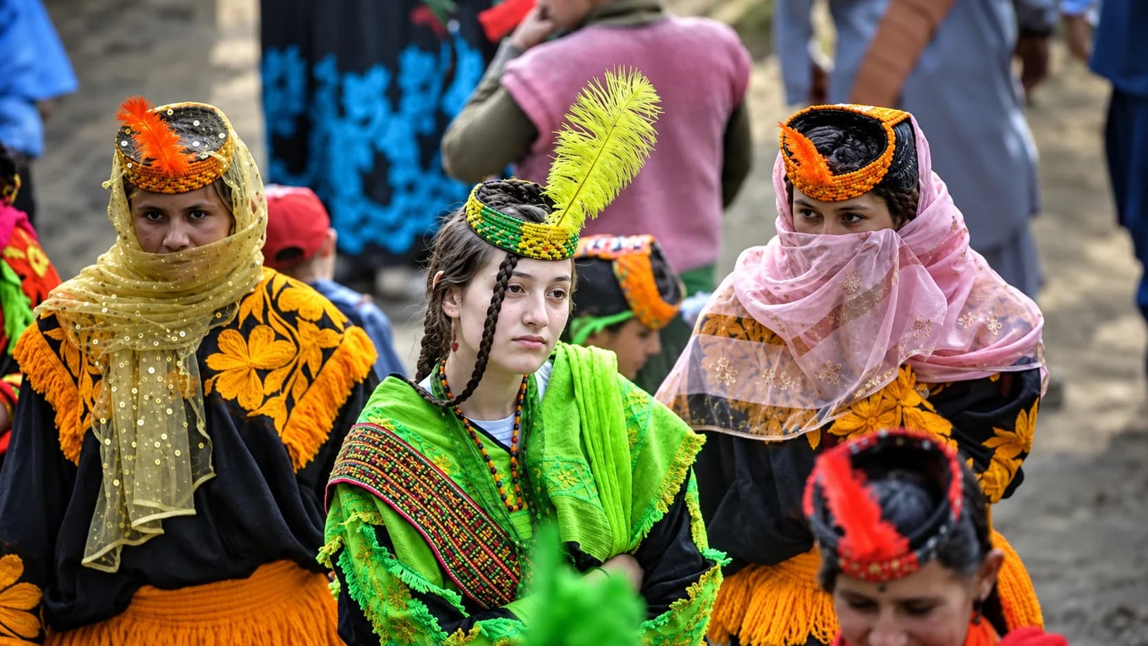 Kalash women wearing traditional embroidered headdresses during a cultural festival in Chitral, Pakistan