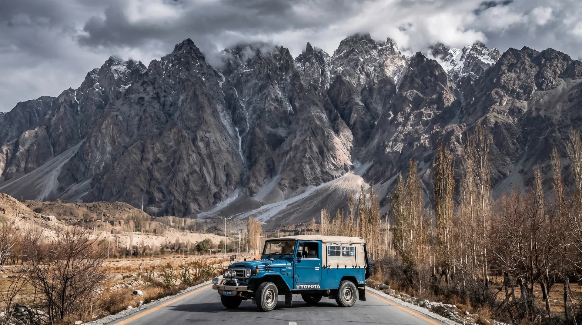 A 4x4 jeep navigating a high-altitude mountain road in Gilgit-Baltistan, northern Pakistan